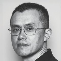 A black-and-white portrait of an Asian man wearing rectangular glasses and a dark shirt, looking directly at the camera with a neutral expression.