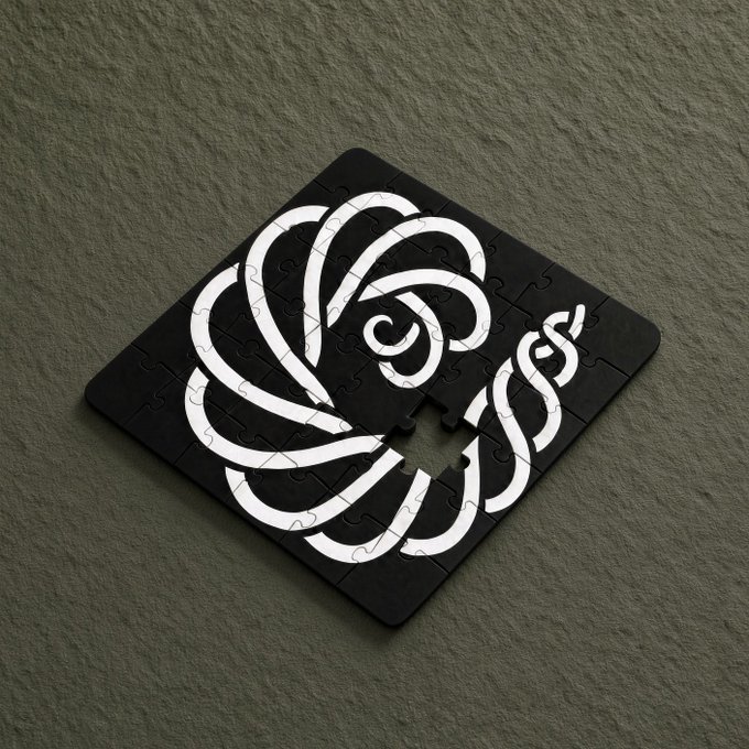 A black square jigsaw puzzle featuring a white swirling rose design rests on a textured gray surface, with one piece missing from the center.
