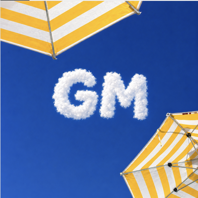 White clouds form the letters "GM" against a vibrant blue sky, framed by two yellow-and-white striped beach umbrellas in the corners—visually echoing the optimistic caption about clear skies ahead for General Motors.
