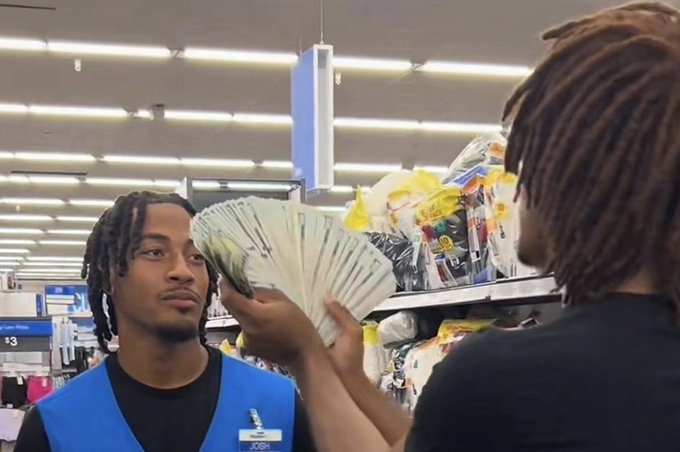 A young man identified by his Walmart name tag as "Josh" is being shown a large fan of cash by a person with dreadlocks in a Walmart store aisle, with the post humorously suggesting he's being taught how to count money as a "$CASH" crypto meme.