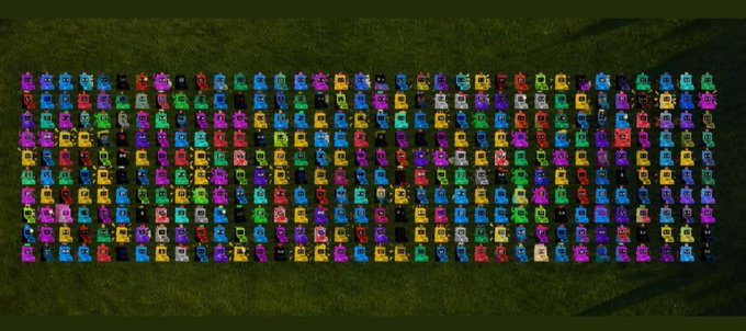 An aerial/top-down view of a large rectangular arrangement of colorful toy race cars organized in neat rows on a green grass surface.