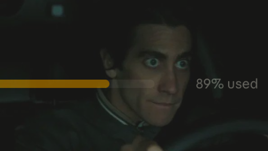 A wide-eyed man in a dark setting (resembling Jake Gyllenhaal from "Nightcrawler") glances anxiously toward the camera, overlaid with a partially filled yellow progress bar reading "89% used." The image humorously illustrates the post's dilemma, visually suggesting the tense moment of deciding between completing an update or being stuck ("bricked") with high usage—playfully mirroring the anxiety of waiting through a large software update.
