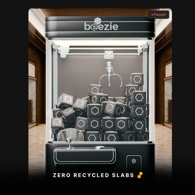 A digital advertisement for 'beezie' showing an empty claw machine with hexagonal blocks at the bottom and the text 'ZERO RECYCLED SLABS.'