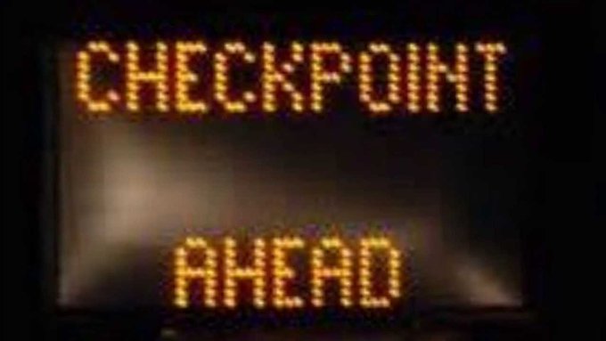 An electronic roadside sign displays "CHECKPOINT AHEAD" in bright amber LEDs against a dark background. The image ties into the post's reference to "First moon coming up?" by humorously suggesting a lunar mission checkpoint is approaching.