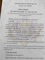 A heavily blurred, partially legible photograph of a printed legal notice or official document.