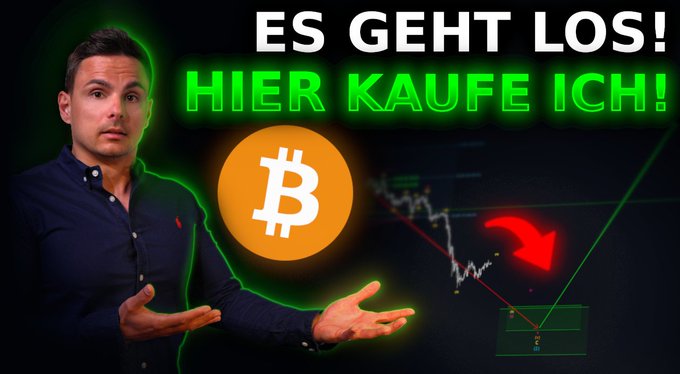 The image features a man standing next to a computer screen, with an orange Bitcoin symbol above him. The text "Es geht los! Hier kaufe ich!" appears below the Bitcoin symbol, which translates to "Es geht los! Hier kaufe ich!". This phrase is likely a reference to the Bitcoin price dropping in the image.