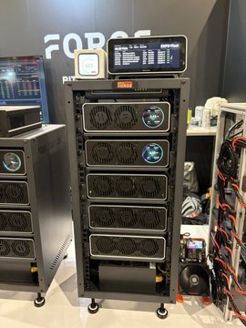 A photo of industrial Bitcoin mining rigs stacked on a rack labeled 'FORCE', featuring digital display screens showing hashrates.