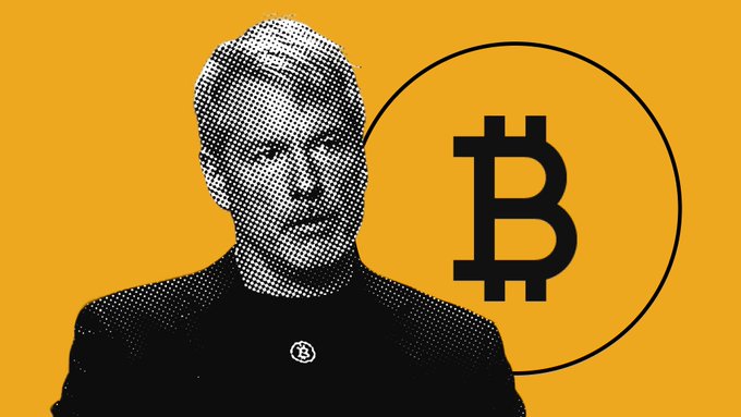 The image features an illustration of a man wearing a black jacket standing next to a large circle with the word "Bitcoin" inside of it. The man's face is visible through a grid pattern around him, giving him an impression as if he's looking at the camera directly. A caption below the illustration reads, "Michael Saylor says that most people will continue to hesitate about buying Bitcoin even if its price reaches $950,000, waiting for a better entry opportunity at $700,000." The image appears to be part of a larger post on social media where Michael Saylor provides insights and advice related to Bitcoin.