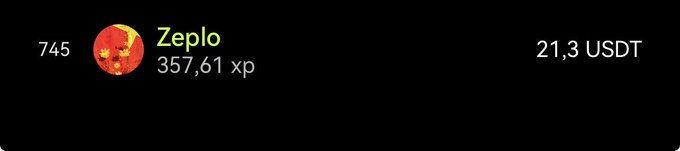 The image shows a long black rectangle with white text, which appears to be a message or information about a cryptocurrency called "Zeplo" that has been posted by someone named "okx". The text includes details such as the current value of Zeplo in USDT and the name of the person who posted it. The image also contains an orange circle with a red dot, which is likely a logo or symbol associated with the cryptocurrency platform where the post was made.