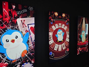 A penguin character holds a "K" playing card against a shattered glass background, with the "K" playing card set against a red casino-style roulette wheel design. These vibrant card-themed visuals appear to be NFTs or digital art celebrating the @pudgypenguins collection.