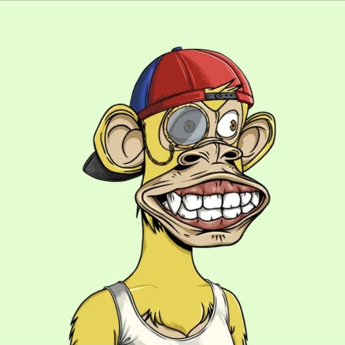 A yellow cartoon monkey wearing a backwards red and blue baseball cap and monocle, showing a large toothy grin on a light green background.
