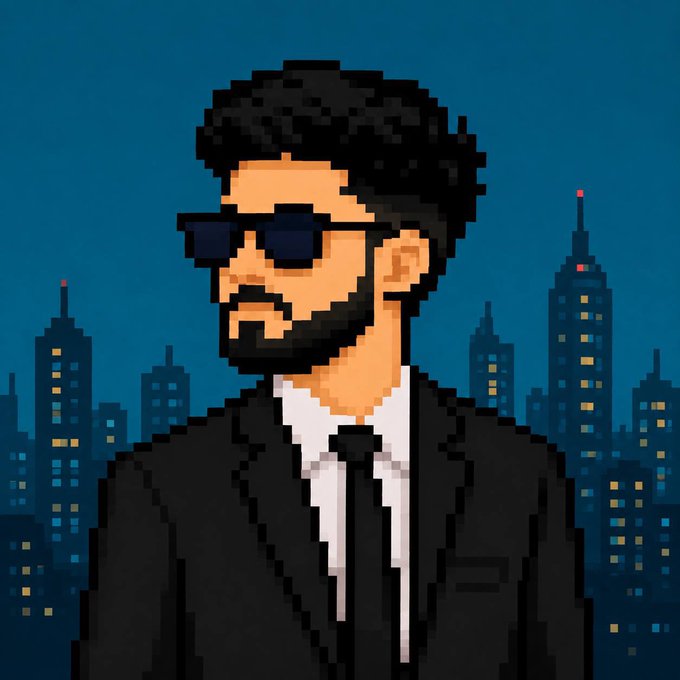 A pixel art style portrait of a bearded man with dark curly hair wearing dark sunglasses, a black suit, white shirt, and black tie, set against a nighttime cityscape with illuminated skyscrapers.