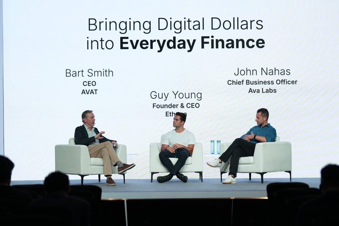 A panel discussion titled 'Bringing Digital Dollars into Everyday Finance' featuring CEOs Bart Smith (AVAT), Guy Young, and John Nahas (Ava Labs) seated on stage.