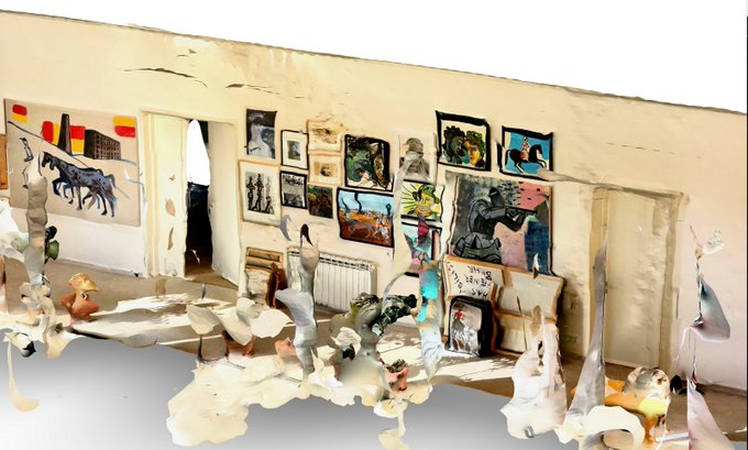 The image shows a room with various objects such as paintings, plants, and furniture arranged throughout the space. The walls are covered in artwork, giving the room an artistic atmosphere. A person can be seen standing near one of the doors, possibly admiring or working on the art displayed. The room is described as a "HOME GALLERY" that has been turned into a digital archive using a GLB 3D scan. It's not a polished showroom but rather a lived space with an immersive and raw artistic experience.