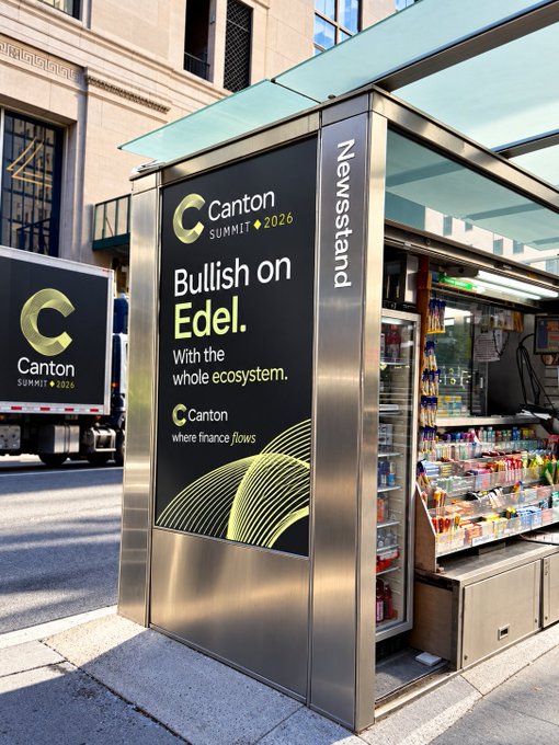 A street-level newsstand kiosk displaying an advertisement for 'Canton Summit 2026' with the slogan 'Bullish on Edel. With the whole ecosystem.'