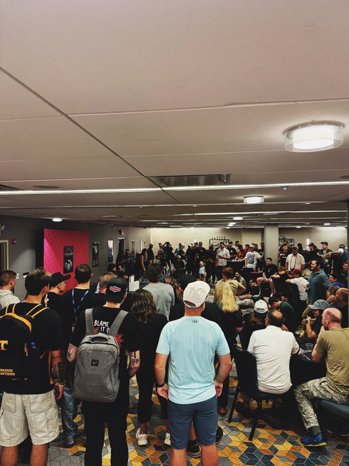 A crowded indoor convention room full of attendees, suggesting a busy event or gathering.