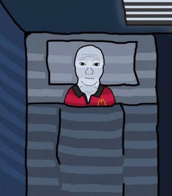 A bald, pale cartoon figure resembling the Wojak meme lies expressionless in bed under a gray striped blanket, wearing a red shirt with the yellow McDonald's "M" logo on the chest. The image visually conveys the emotional toll and loneliness expressed in the post, depicting the creator as neglected and discarded by the community after they stopped giving away $LINA tokens for free.