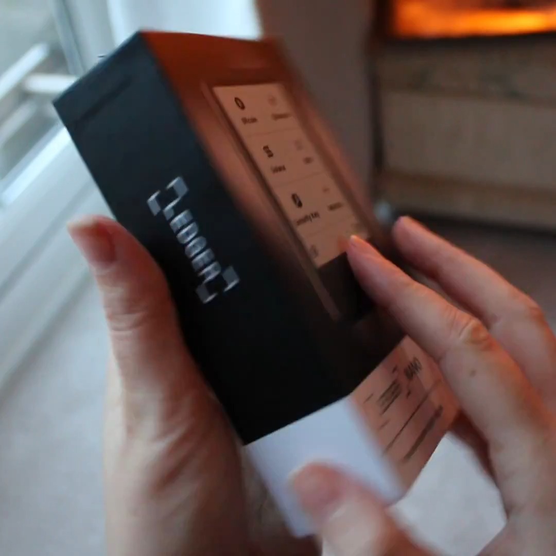 A person holds a new Ledger Nano Gen5 device, still partially wrapped, with the packaging displaying "GEN5" branding. The image captures the unboxing moment, illustrating the "upgrade" experience referenced in the post.