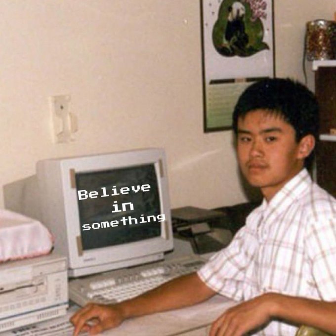 A young man sits at a vintage CRT computer displaying the text "Believe in something," capturing a nostalgic late-90s/early-2000s tech aesthetic that contrasts with the post's commentary on crypto success stories like Solana, SBF, and Hyperliquid. The meme's juxtaposition suggests that genuine belief in fundamentals—rather than wealth-driven promotion—is what truly powers successful products.