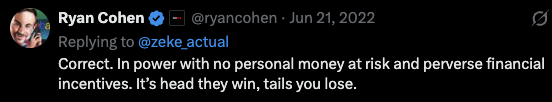 The image shows a person's face, possibly a man or woman, with text that reads "In power with no personal money at risk and financial incentives. It's head they win. tails you lose." The focus of this image is on the message in the caption about the Hollow Men.