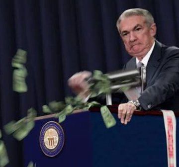 Fed Chair Jerome Powell stands at a podium as cash is thrown into the air, symbolizing aggressive money-printing, with the Federal Reserve seal visible—aligning with the post's quip about the "printing press" staying open while markets pressure him to pivot.