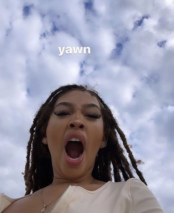 A woman with locs is captured mid-yawn against a cloudy blue sky, with the word "yawn" displayed above her. The image playfully illustrates the post's theme of exhaustion from early-rising crypto friends who say "GM" at 6am.