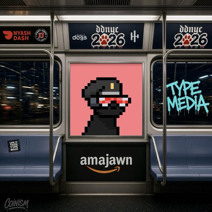 Subway car interior featuring advertisements including 'ddnyc 2026', 'TYPE MEDIA', 'NYASH DASH', and an Amazon logo with the text 'amajawn' below a pixel art portrait.