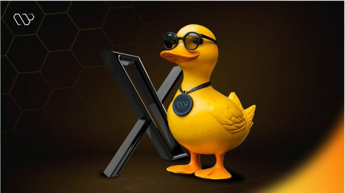 The image features a yellow duck figurine wearing glasses, standing next to a black x-shaped object. The duck has a name tag that reads "Quack" and is accompanied by a small plaque with the text "GM Friday Today I received 3.2 Quack from @wallchain". The post appears to be promoting a product or service related to ducks, as suggested by the name tag on the figurine.