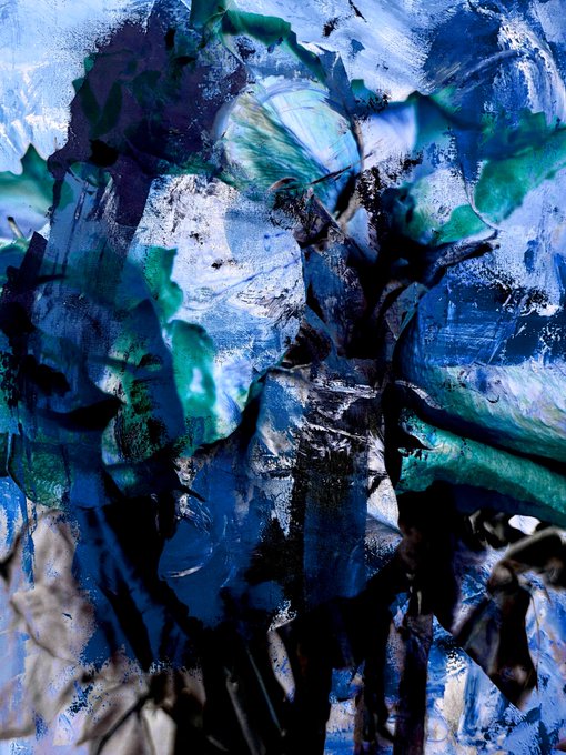 A close-up abstract painting features thick, textured brushstrokes blending deep blues, blacks, greens, and whites, creating a dynamic and chaotic visual composition.