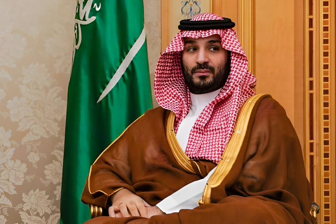 Saudi Crown Prince Mohammed bin Salman sits in formal traditional attire beside the Saudi Arabian flag, with the accompanying post reporting that Saudi government-owned Gulf International Bank (UK) has disclosed a $2.27 million stake in Bitcoin treasury company Strategy ($MSTR), highlighting Saudi financial institutions' growing exposure to cryptocurrency.