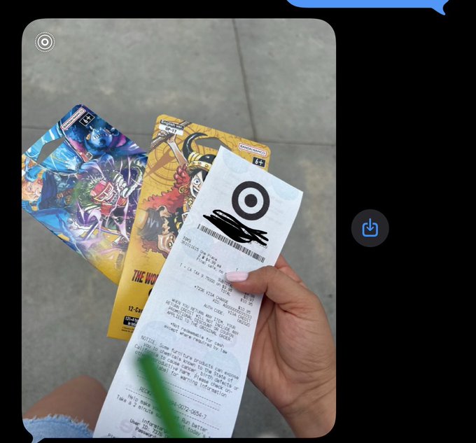A person's hand holds a Target receipt alongside two gift cards featuring colorful video game artwork.
