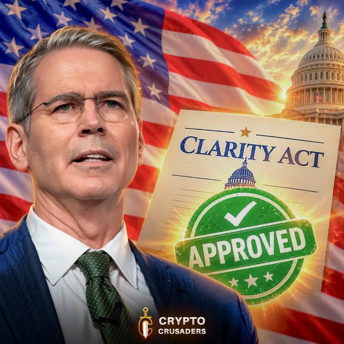 A political/crypto promotional image showing a man with glasses in a suit in front of an American flag and US Capitol, alongside a 'CLARITY ACT APPROVED' stamp and the 'CRYPTO CRUSADERS' logo.