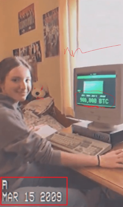 A meme-style photo of a young woman at an old computer displaying '500,000 BTC', with the date 'MAR 15 2009' and red drawings added.