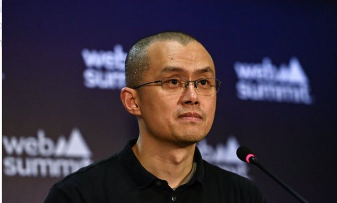 The image features a man wearing glasses standing at a podium with his mouth open, possibly speaking or addressing an audience. The background of the image shows a sign that reads "Web Summit", indicating that this could be a conference or event related to web development or technology.