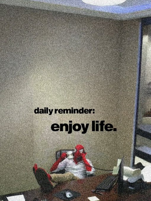 A pixelated image shows a person with red hair sitting at a desk with their feet propped up, overlaid with the text "daily reminder: enjoy life." The laid-back office pose and motivational message perfectly complement a TGIF morning post, reinforcing the carefree Friday mood.