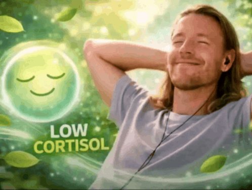 An advertisement-style image featuring a smiling man with earbuds next to a glowing green emoji and the text 'LOW CORTISOL', promoting stress reduction.