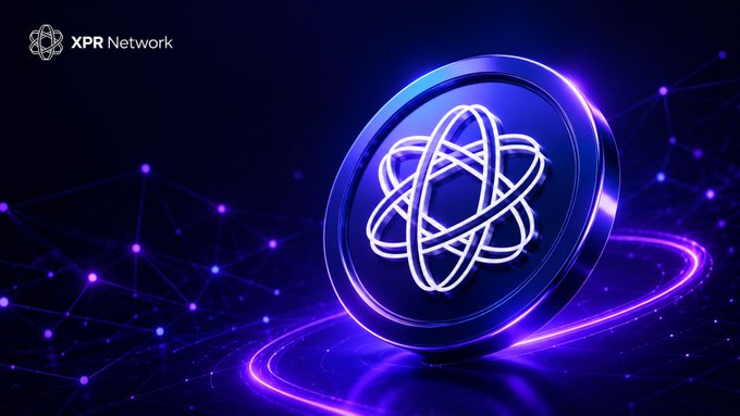 The image features a blue circular coin with an atomic symbol, which appears to be floating or hovering above a dark background of purple lines and dots. The text "XPR Network" is visible at the top left corner of the image, while the phrase "Build from zero" can be seen in the bottom right corner. The coin's position and the surrounding elements create an interesting visual effect that draws attention to the atomic symbol on its surface.