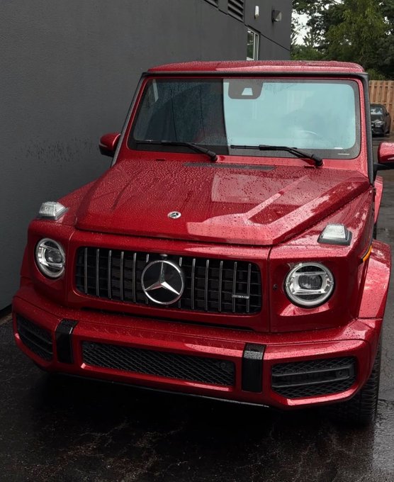 A sleek red Mercedes-Benz G-Wagon with a prominent chrome grille and three-pointed star emblem is parked on a wet surface, glistening from recent rain. The image's connection to the post is metaphorical—the G-Wagon's reputation for rugged, high-performance luxury infrastructure parallels Beldex Coin's focus on building a robust privacy infrastructure, rather than just promising results, for decentralized networking through its Masternodes, BelNet, and BChat.