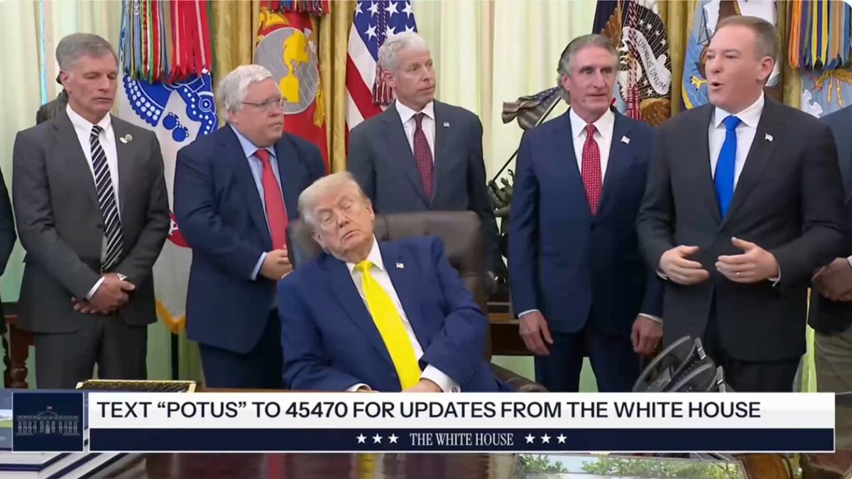 The image shows a group of men dressed in suits, standing around each other with some of them looking tired or sleepy. The man sitting down appears to be sleeping, while others are standing nearby. The background features several flags, including the American flag, which is prominently displayed on the wall behind the group. The text "Text 'potus' to 4570 for updates from the white house" and "The guy is 79 years old Not much life left 10 years to 90 years maybe if they keep injecting him with hormones Trump destroyed the USA economy while making politicians and ceos rich from #stocks and #crypto rug pull $trump".