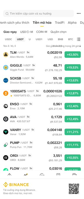 A Binance mobile app screen showing a cryptocurrency market list with trending coins like TLM, GIGGLE, SOXSB, 1000SATS, ENSO, AVA, VANRY, PUMP, ORDI, and FLOW, displaying price gains between approximately 9% and 43%.