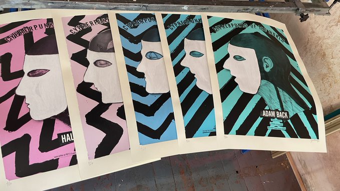 Five screen-print posters are laid side by side, each showing a stylized profile portrait against bold graphic patterns in pink, blue, and turquoise. Visible text includes “CYPHER PUNK,” “HALFIN,” and “ADAM BACK,” matching the accompanying Cypherpunks exhibition artwork and artist Adam Back.