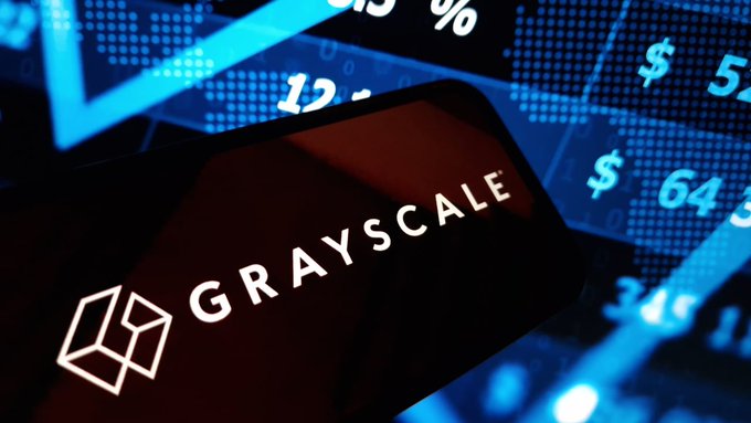 A smartphone screen displaying the 'GRAYSCALE' logo against a blue background of financial charts and numbers.