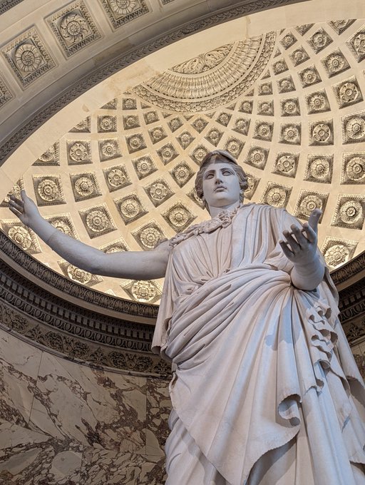 A triumphant marble statue with outstretched arms stands beneath an ornate coffered dome, radiating a sense of limitless power and freedom. The image perfectly captures the exhilarating moment when your token budget resets, arms flung wide to embrace a fresh flood of possibility.
