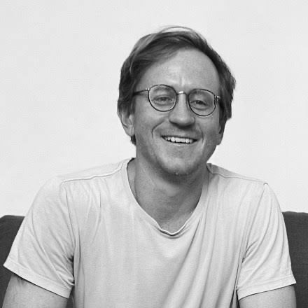 A smiling man in glasses is pictured, suggesting he is the speaker or someone influential in the discussion about Ethereum being considered "other chains" by @aerugoettinea in the accompanying post.