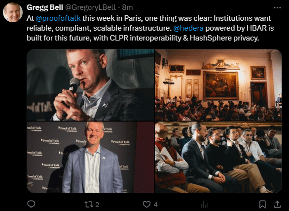 The image shows a man speaking at an event with a microphone, surrounded by several people sitting in chairs. The caption of the image reads "At @hedera powered by HBAR is built for this future", which suggests that the image might be related to a speech or presentation given by the man at the event.