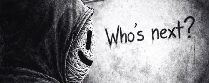 A black and white moody image showing a close-up of a figure wearing a textured mask next to graffiti text reading 'Who's next?' on a wall.