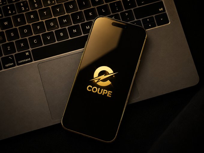 A smartphone displaying a glowing gold "COUPE" logo rests on a laptop keyboard in dim lighting, evoking a sense of secretive late-night crypto or app activity that aligns with the dismissive "probably nothing" tone—suggesting something significant is being downplayed.