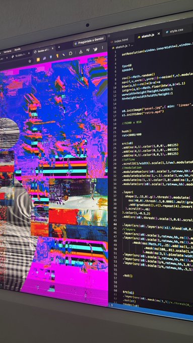 A photograph of a computer monitor displaying 3D rendering shader code (sketch.js and style.css) alongside a highly colorful, glitchy 3D test render scene.