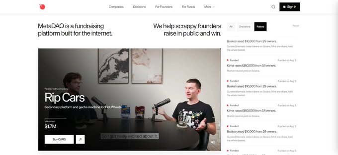 A screenshot of the MetaDAO website, describing it as a fundraising platform for the internet, featuring a video of two men discussing 'Rip Carts' at Hot Wheels.