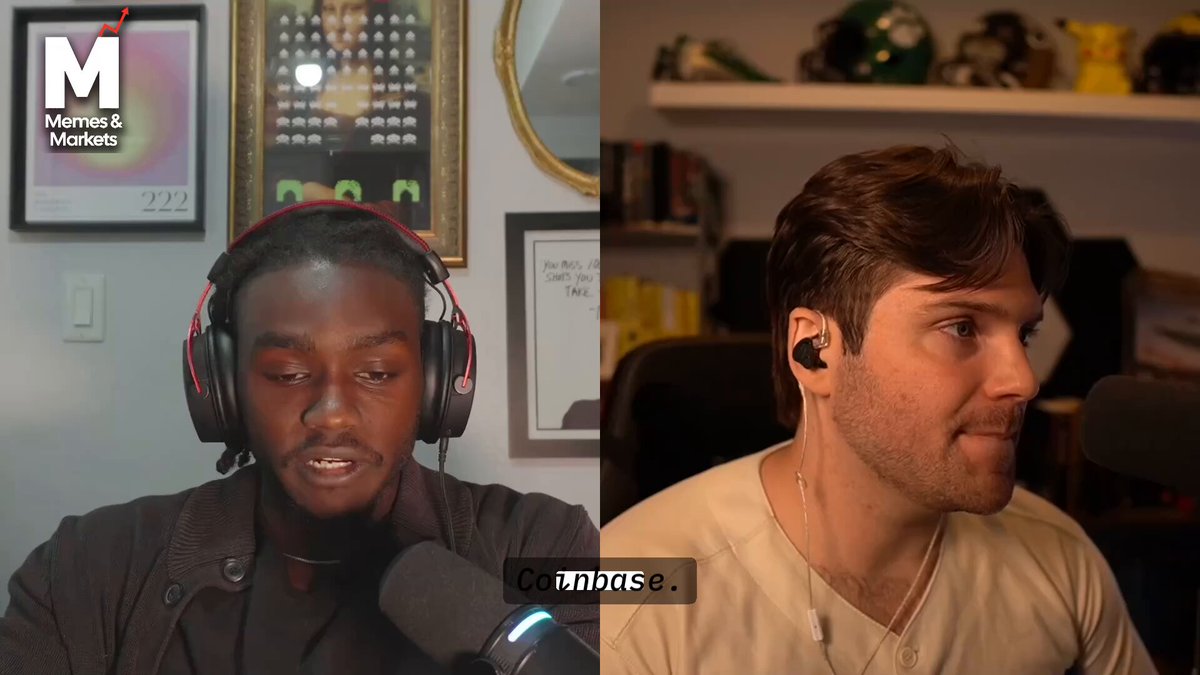 The image shows two men wearing headphones, with one man sitting at a desk and the other standing behind him. They are both talking into microphones, suggesting they might be participating in an interview or a podcast recording session. The background features a wall clock and a picture frame on it, indicating that this scene takes place in a room where timekeeping is important.